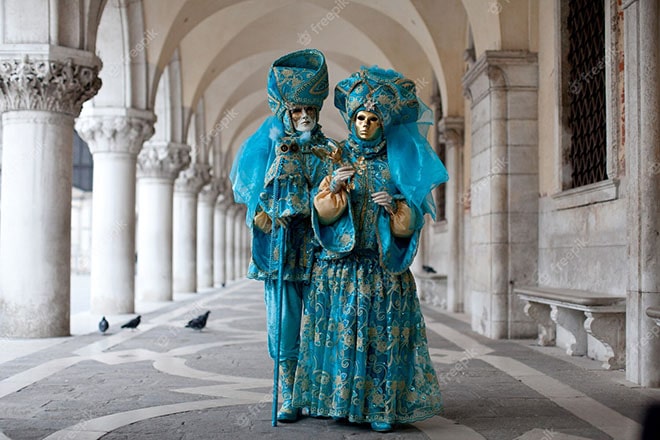 Venice | Luxury Italy Travel Agent masked couple ornate costume venetian masquerade stands near st mark s square venice 120968 408 min . Luxury Italy Travel Agent